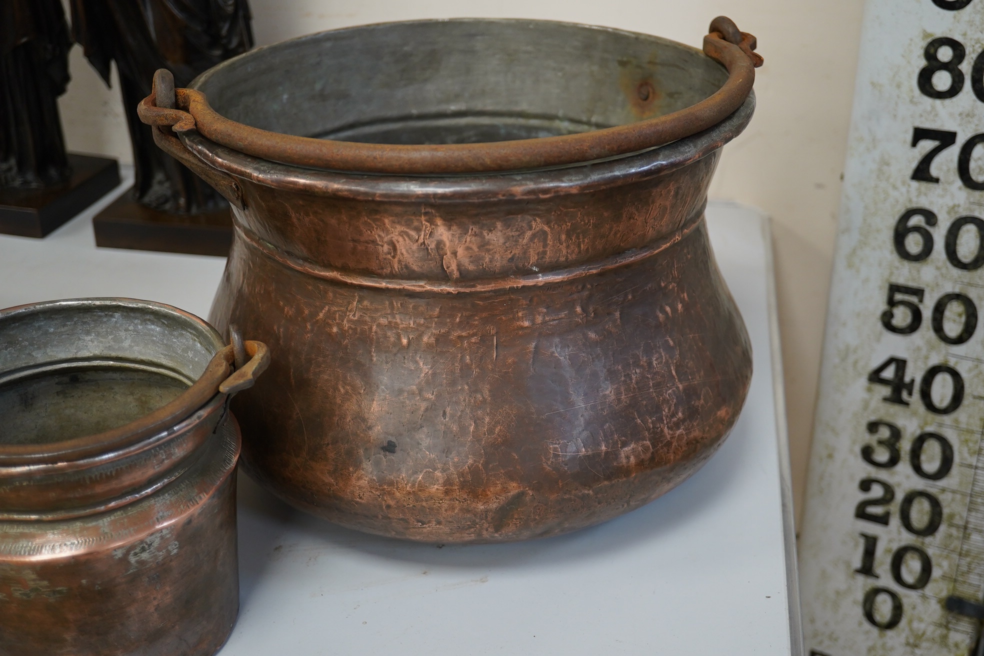 A set of three graduated coppered buckets with swing handles. Largest 22cm high. Condition - fair